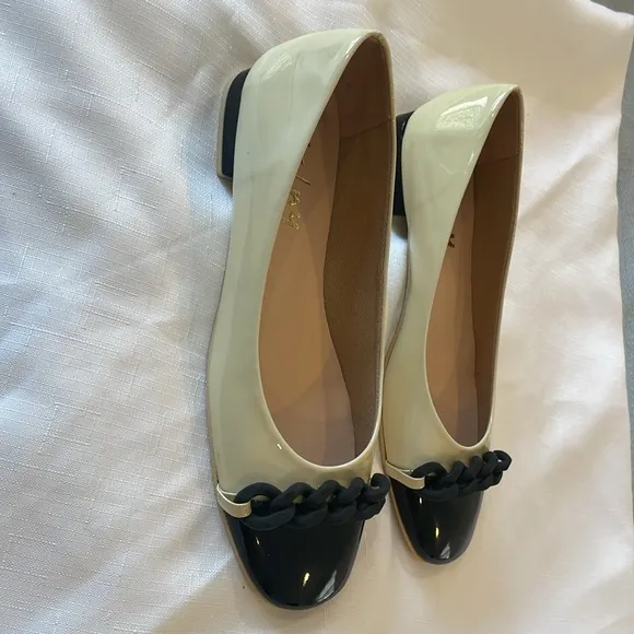 FRENCH SOLE BRAIDED FRONT DESIGN, FLATS ARE CREAM AND BLACK.   NEW IN BOX