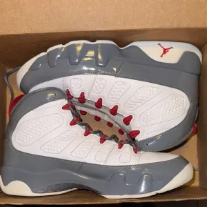 Jordan White and Gray Athletic Shoes with Red Accents