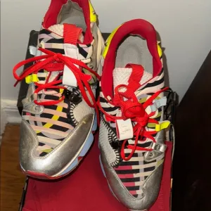 Red Sole Sneakers with Bold Design